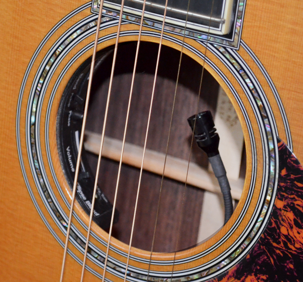 The built-in pickup system on this acoustic guitar allows the performer to blend two different pickup sources that are sent to a single output jack which gets connected to a direct box and the PA. 